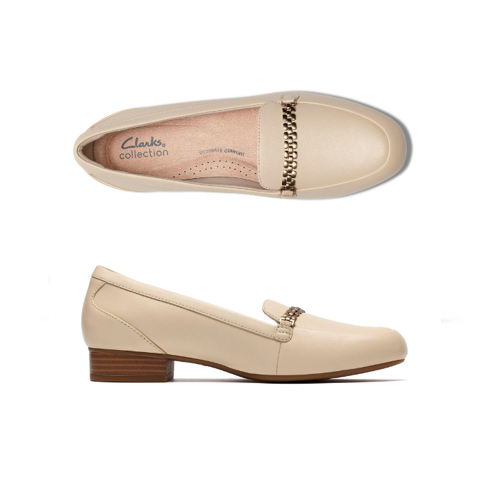 Pair of Beige loafer shoes with a gold chain detail, tan Clarks logo'd footbed and low stacked heel.