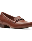 Tan leather loafer with low heel and strap detailing on toe.
