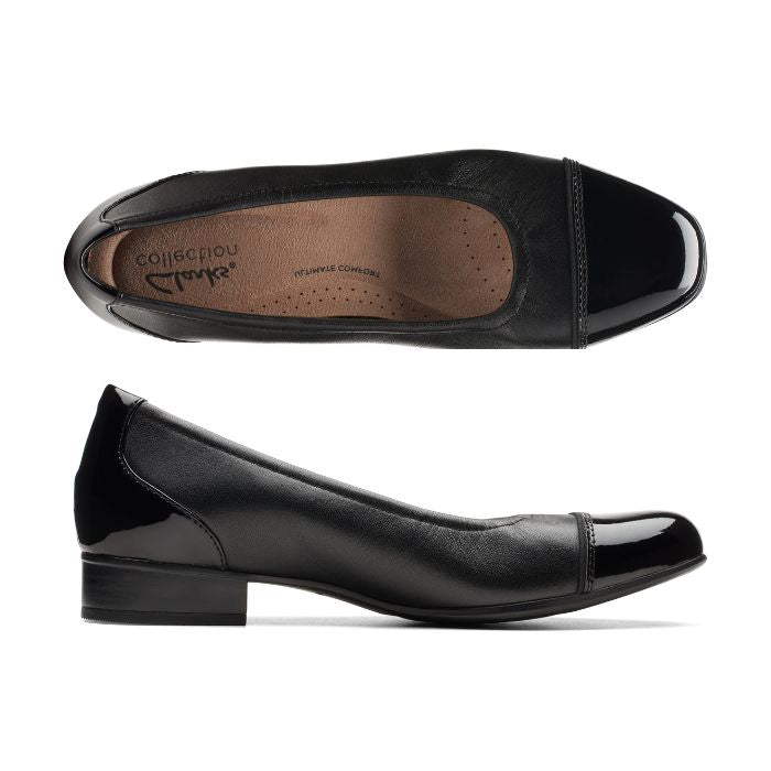 Black leather flat with patent toe and heel accents with low stacked heel. Clarks logo printed on brown insole.