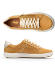 Pair of Yellow sneakers with gold side zipper, white laces, white heel accent, Clarks logo'd tan footbed, white midsole and brown outsole.