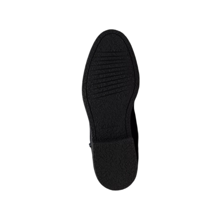 Black rubber outsole of tall boot.