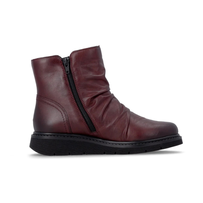 Deep burgundy ankle boot with side zippers, ruching and black treaded outsole.