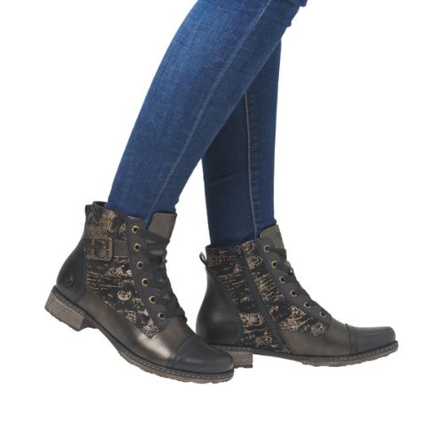 Bronze ankle boots with light accents worn with blue jeans.