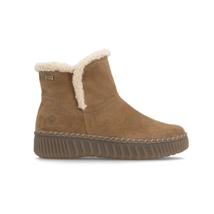 A brown suede ankle boot with a cream shearling-style lining and a chunky brown outsole.