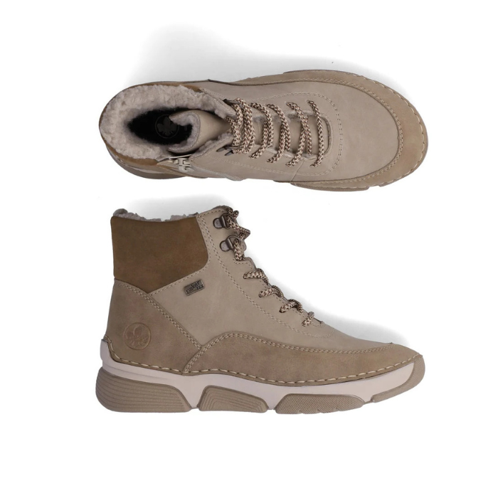 Pair of Light beige lace-up ankle bootswith darker beige accents, brown and beige treaded outsole and fur lining.