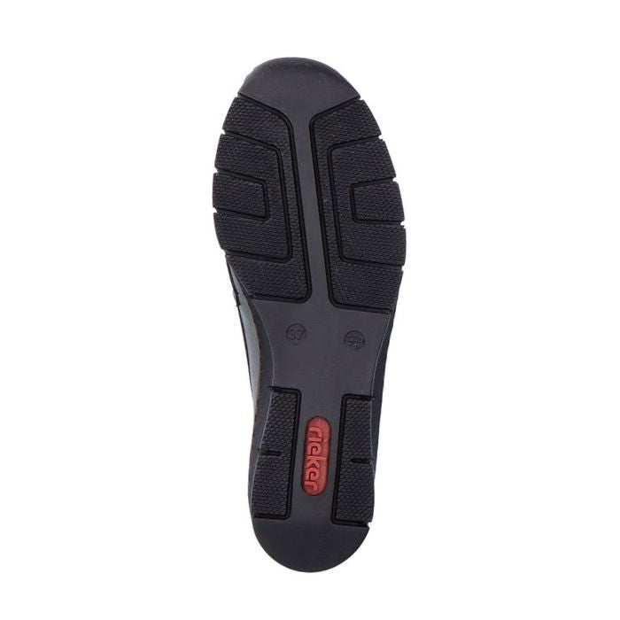 Black rubber outsole of women's wedge shoe with red Rieker logo on heel.