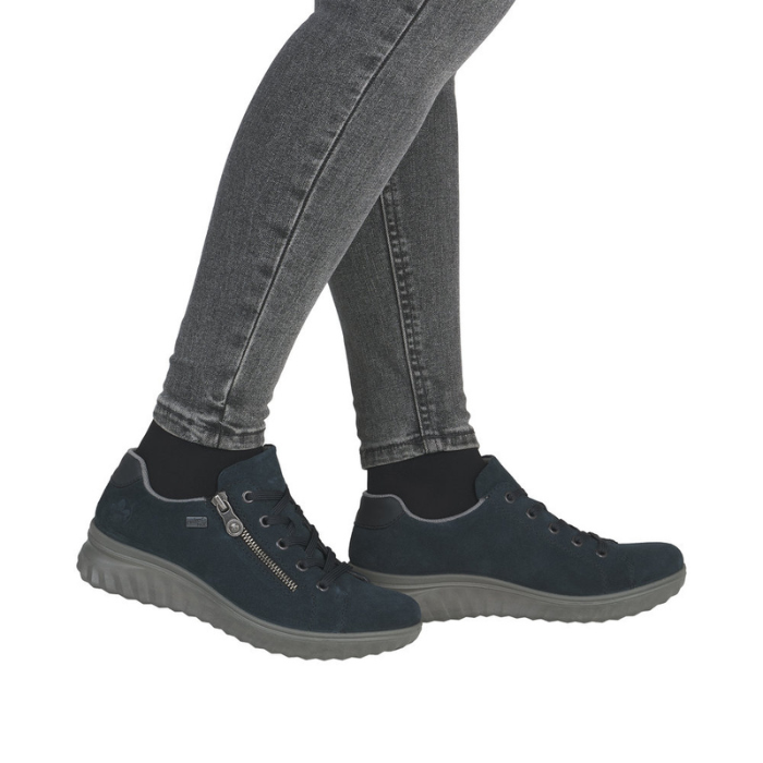 Navy blue casual shoes worn with gray jeans.