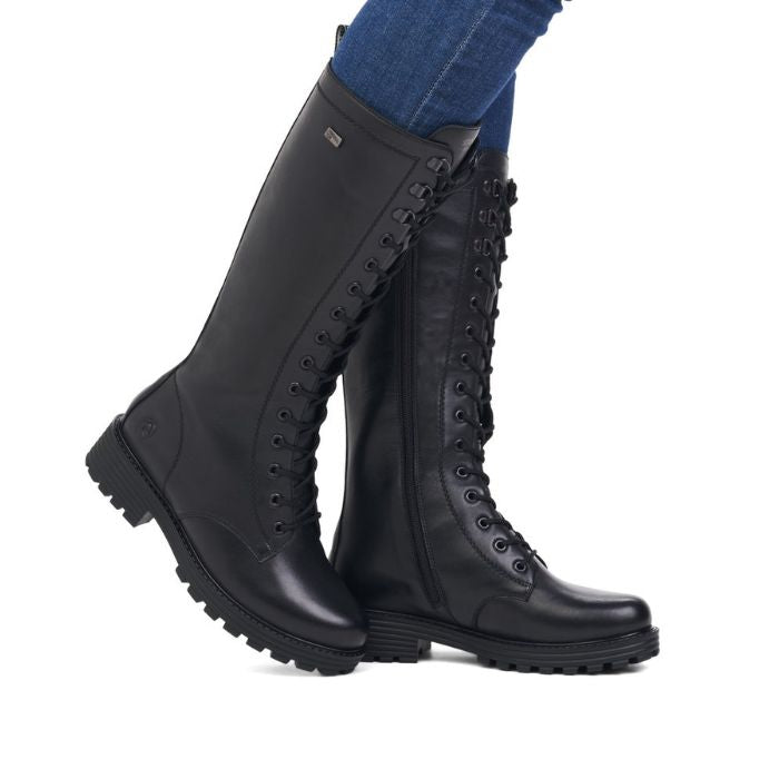 Tall leather lace up boot with lugged black outsole.