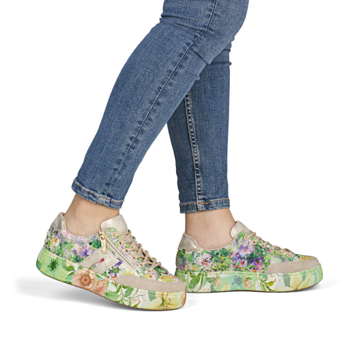 Floral sneakers worn with blue jeans.