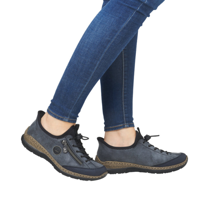 Model wearing blue-grey bungee lace Slip-On Sneakers with jeans.