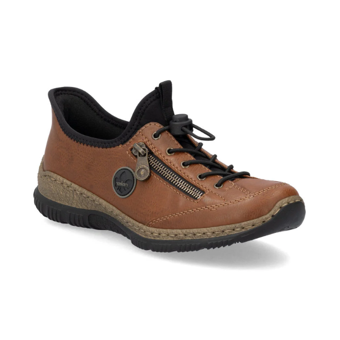 Brown slip-on shoe with bungee laces, faux side zipper, Rieker logo in circle side emblem, brown faux cork midsole and a black outsole.