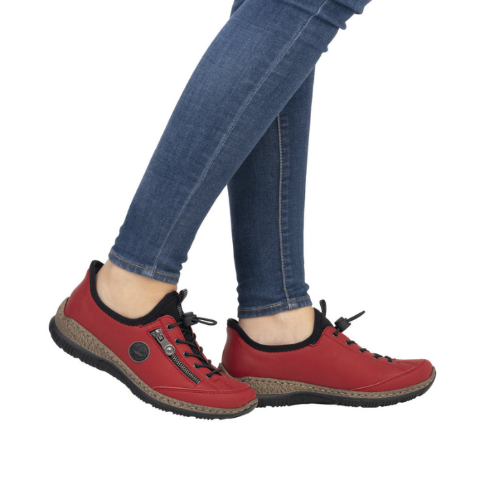 Model wearing red bungee lace Slip-On Sneakers with jeans.