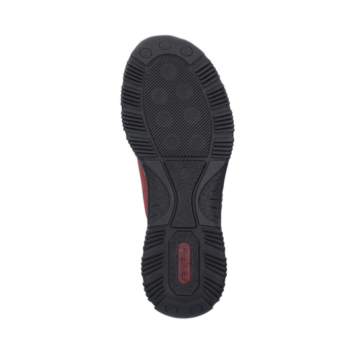Black light treaded outsole of slip on shoe with red Rieker logo on heel.