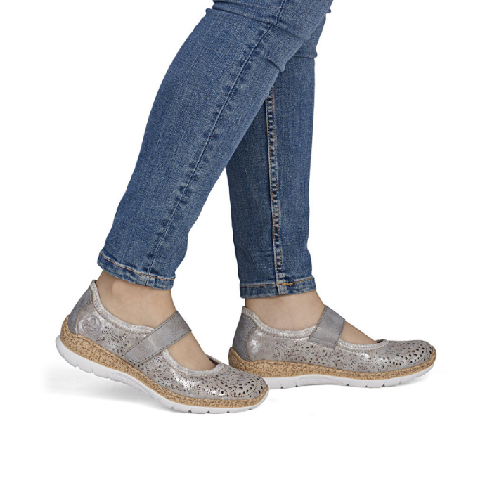 Silver Mary-Jane shoes worn with blue jeans.
