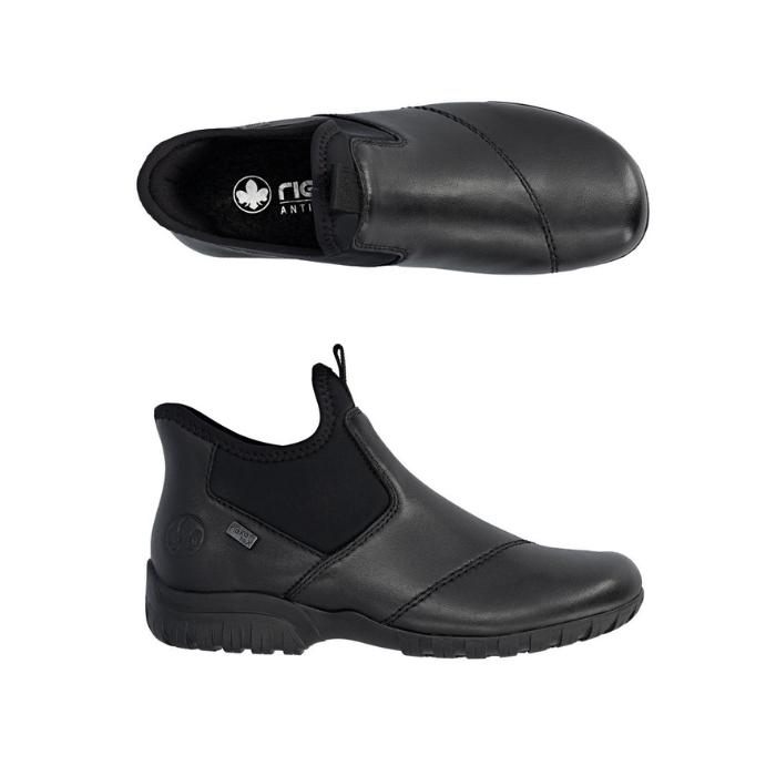 Pair of Black leather slip on ankle boots with accent elastic panels, Rieker logo on black footbed and a black rubber outsole.