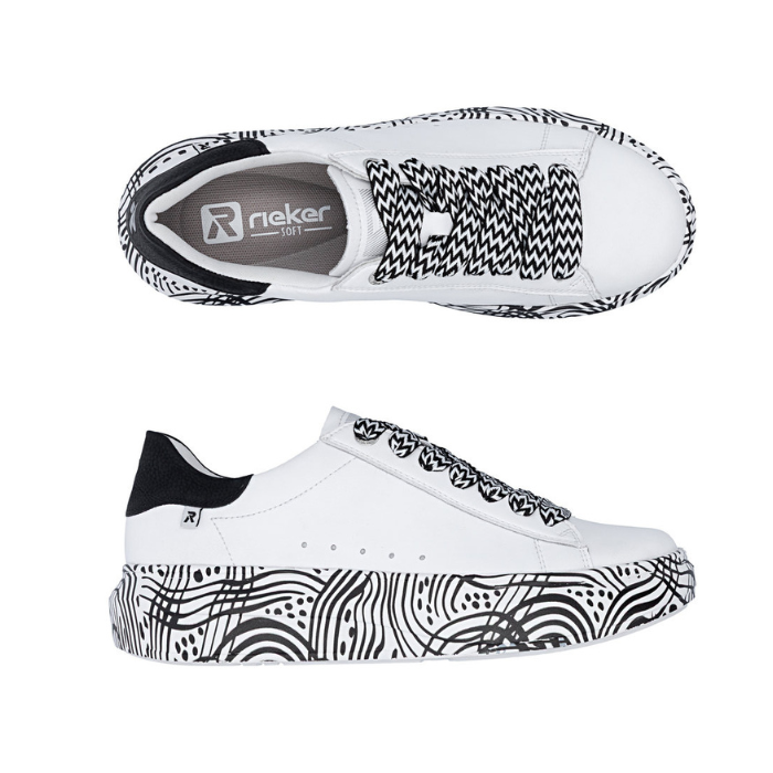 Pair of White platform sneakers with black and white laces, tan Rieker logo'd footbed, black heel counter and a black geometric line pattern on midsole.