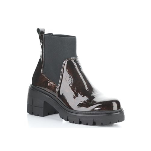 A marbled dark brown patent heeled Chelsea boot with elastic side goring, a heel pull tab, and thick lugged outsole.