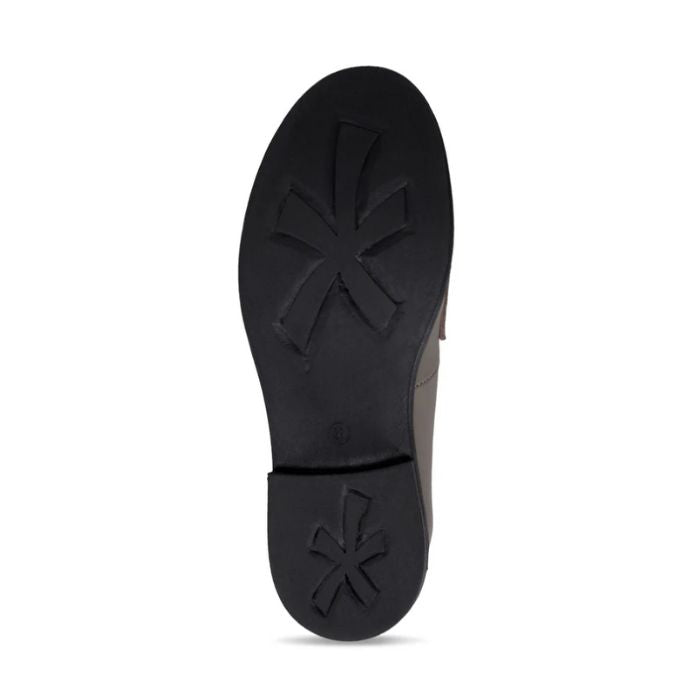 Black treaded outsole with flower pattern on ball and heel of shoe.