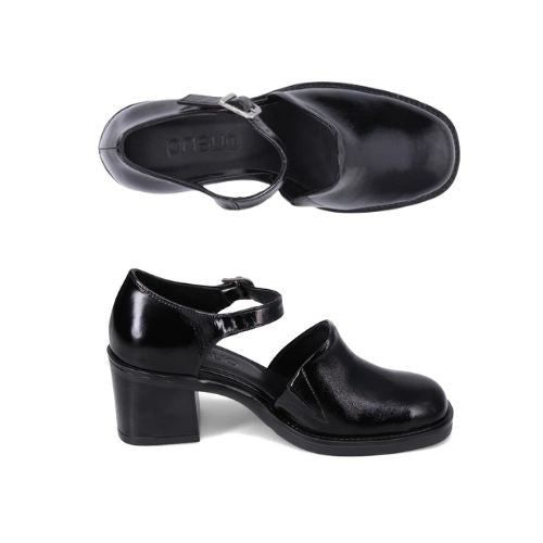 Pair of Black leather closed toe heel with a block heel, black Bueno logo'd outsole and silver buckle strap.