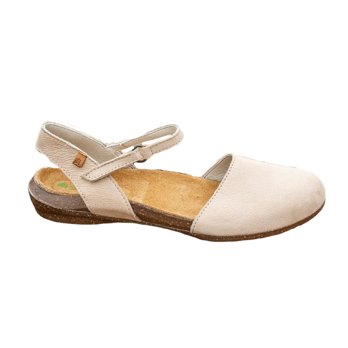 Beige closed toe sandal with a Velcro strap and brown speckled foot.