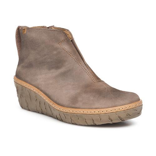 A brown suede wedge bootie with a zipper on the side, elastic cut out on front and tan midsole accent.