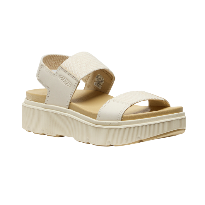Beige sandal with toe, vamp and back strap, tan footbed and platform outsole.