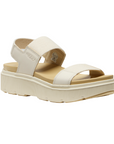 Beige sandal with toe, vamp and back strap, tan footbed and platform outsole.