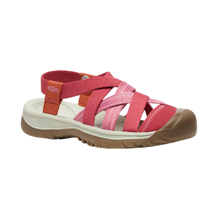 Walking sandal with criss crossing straps in various shades of pink and rugged brown outsole.