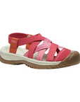 Walking sandal with criss crossing straps in various shades of pink and rugged brown outsole.