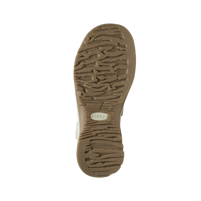 Brown treaded outsole of sandal with Keen logo in middle.