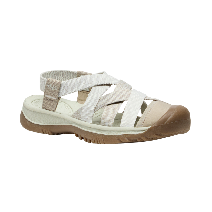 Walking sandal with criss crossing straps in various shades of white and rugged brown outsole.