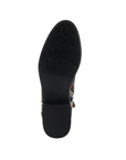 Black rubber outsole with a flower and vine tread pattern at the ball of the foot and a light treaded low block heel.