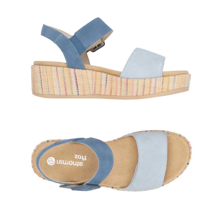 A pair of light blue platform sandals with dark blue backstrap, tan Remonte logo'd footbed and a woven multicolor striped wedge sole.