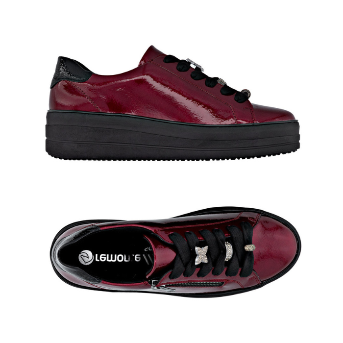 Pair of Burgundy patent leather sneakers with black laces, sparkly lace charms, side zipper and black platform outsole.