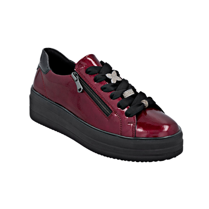 Burgundy patent leather sneaker with black laces, sparkly lace charms, side zipper and black platform outsole.