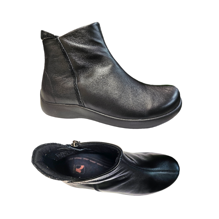 Pair of black leather ankle boots with side zipper and Revere logo on black footbed.