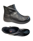 Pair of black leather ankle boots with side zipper and Revere logo on black footbed.
