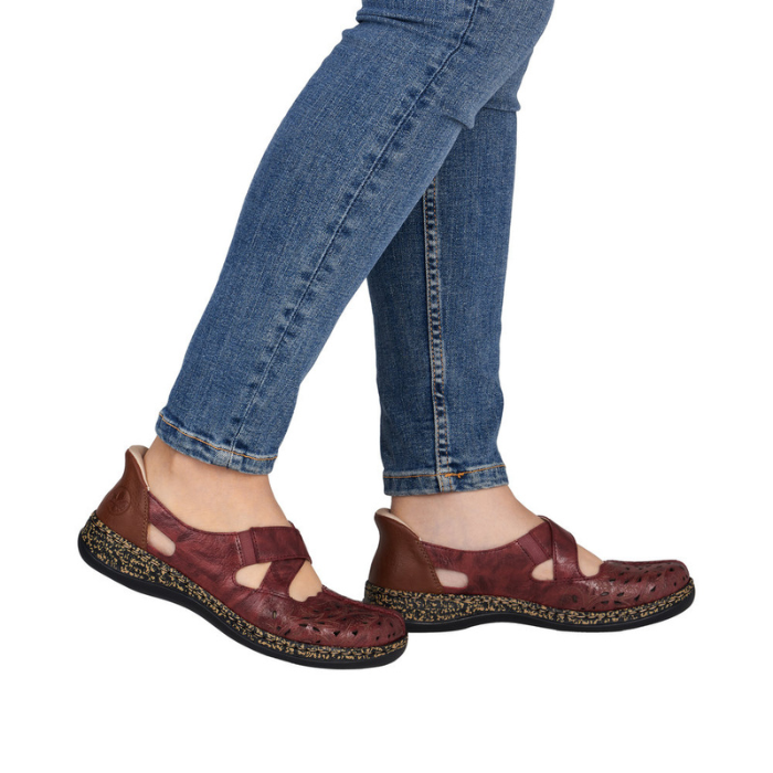 Red Mary-Janes worn with blue jeans.