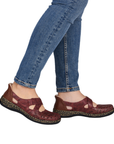 Red Mary-Janes worn with blue jeans.