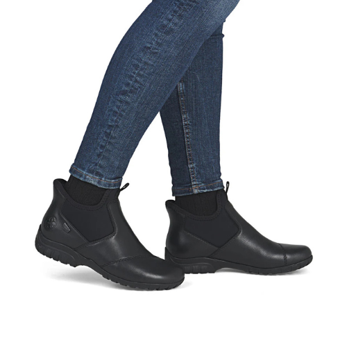 Black step-in ankle boots worn with blue jeans