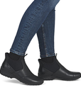 Black step-in ankle boots worn with blue jeans