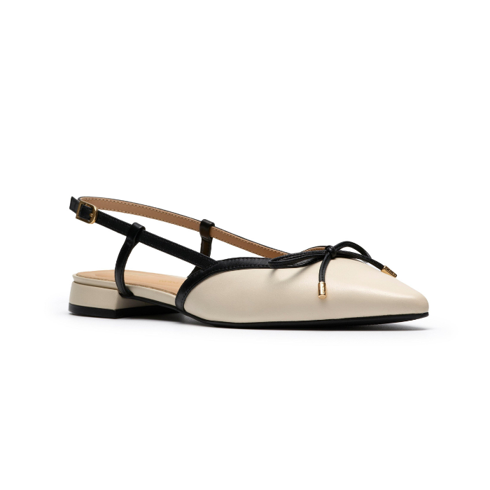 Pointed-toe slingback flat with black bow detail, cream upper and a low block heel.