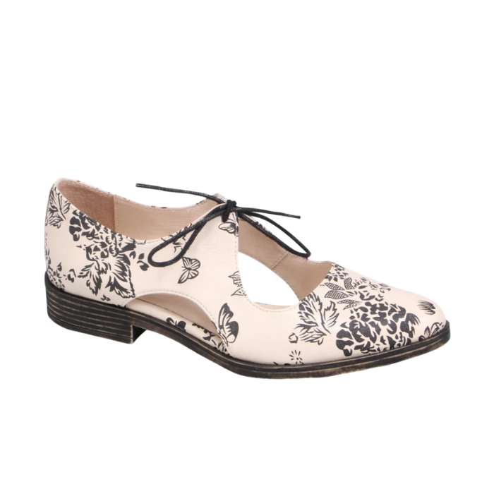 Beige leather oxford with black floral print, d’Orsay side cutouts and low stacked heel.