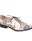 Beige leather oxford with black floral print, d’Orsay side cutouts and low stacked heel.