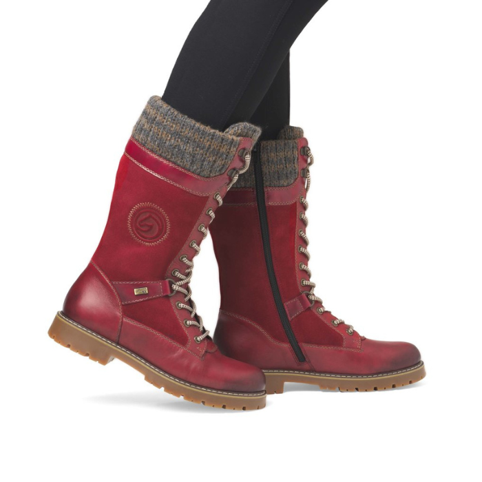 Red Suede and leather mid calf boot with grey knit cuff worn with black leggings.