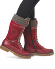 Red Suede and leather mid calf boot with grey knit cuff worn with black leggings.
