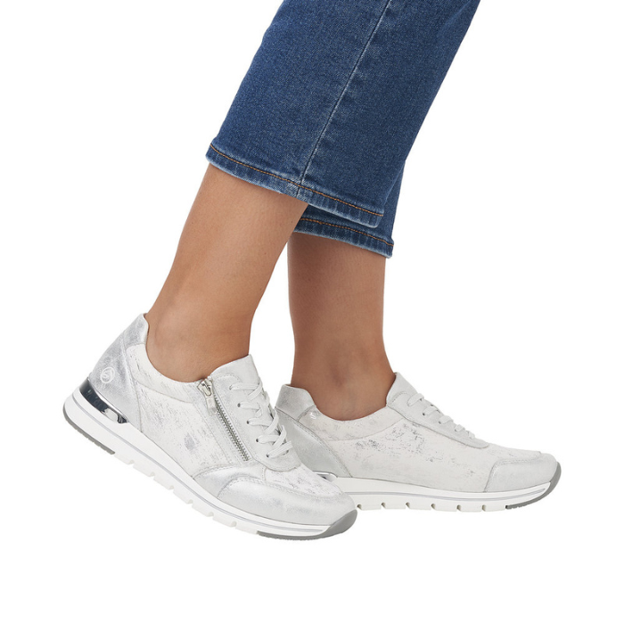 Silver sneakers worn with blue jeans.