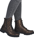 Leopard print boots worn with gray jeans.