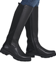 Black knee high boots worn with blue jeans.