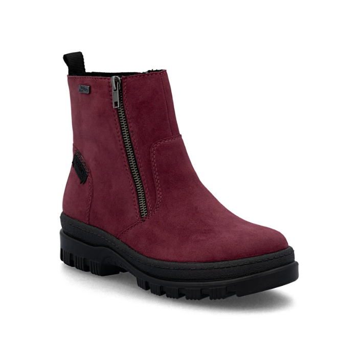 A burgundy suede ankle boot with a black side zipper, black pull tab, and a chunky black lug outsole.